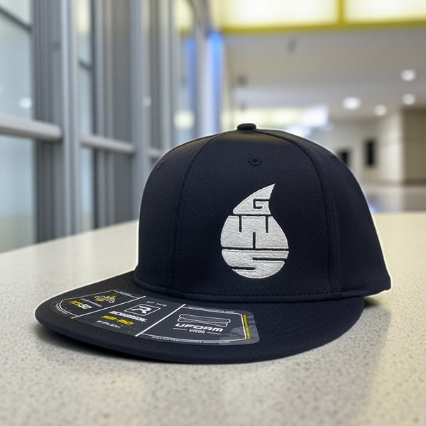 Black Richardson fitted hat with white embroidered GWS water drop logo, placed on a modern indoor surface.