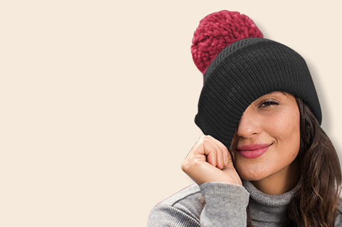 A girl wearing a beanie with a red pom